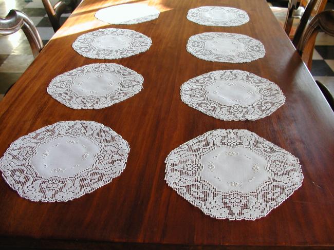 Gorgeous set of eight linen doilies with hand worked filet lace.