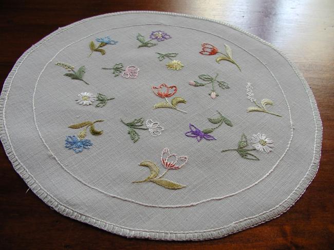 Charming round doily with embroidered field flowers