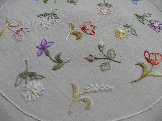 Charming round doily with embroidered field flowers