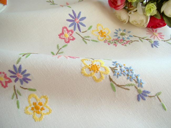 Breathtaking tablecloth with hand-embroidered garland of spring flowers
