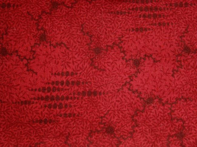 Coupon de coton à fond nuagé rouge foncé avec nervures et feuilles