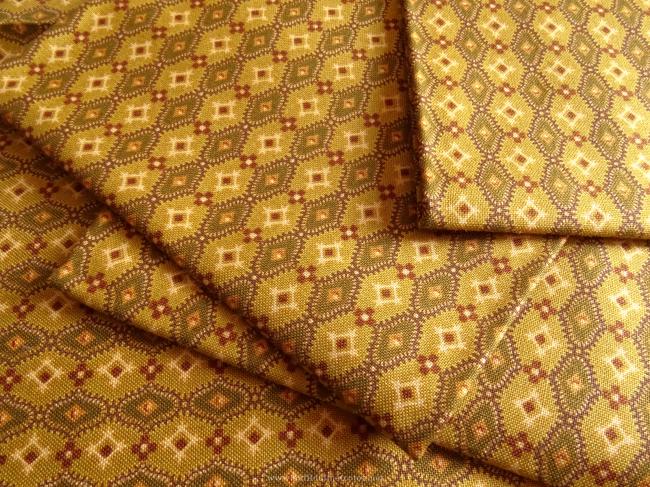 Coupon de coton à fond moutarde et motif géométrique bronze
