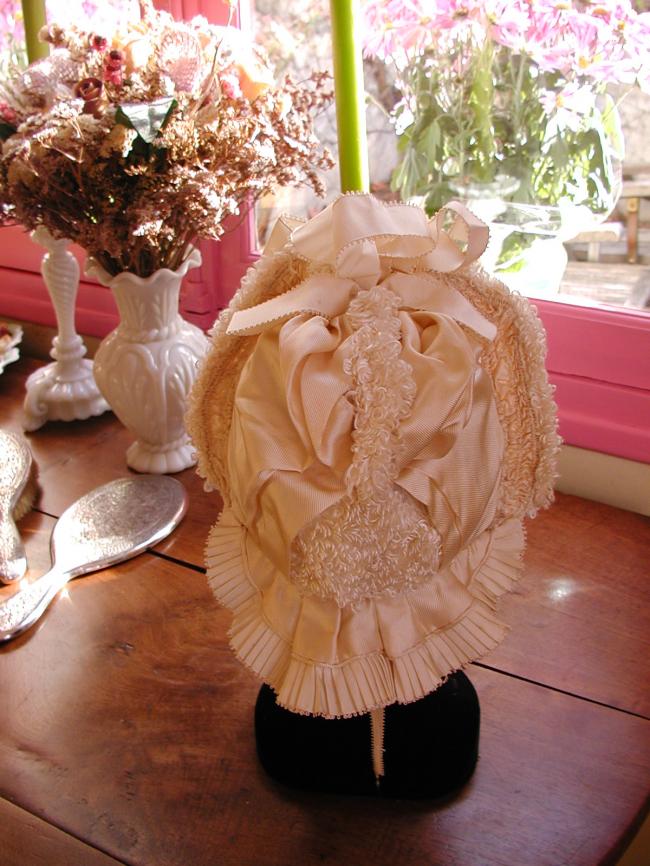 Exceptional baby bonnet-hat  in ivory silk, ribbon and bouclette of silk  1880