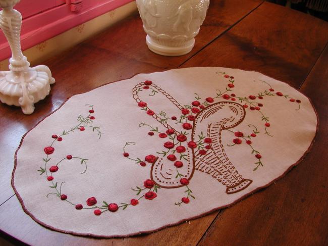Really beautiful oval table centre with embroidered basket of red roses