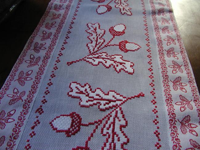 Superb table runner with red and white cross stitches, with lots of acorns