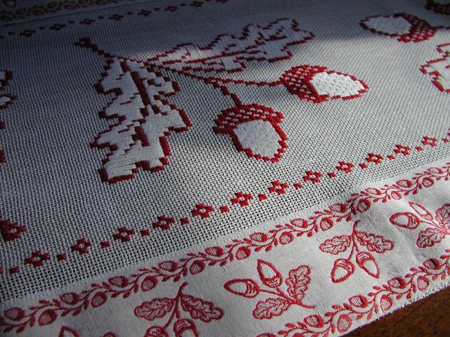 Superb table runner with red and white cross stitches, with lots of acorns